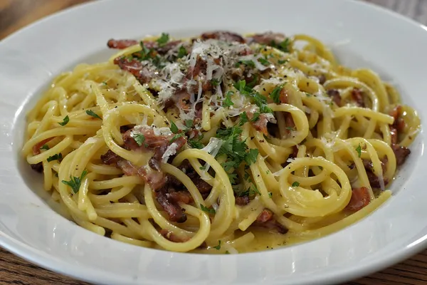 A plate of spaghetti alla carbonara with guanciale and pecorino